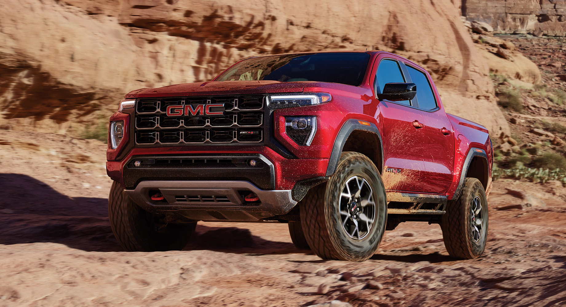 Rugged red GMC Canyon on a rocky desert trail