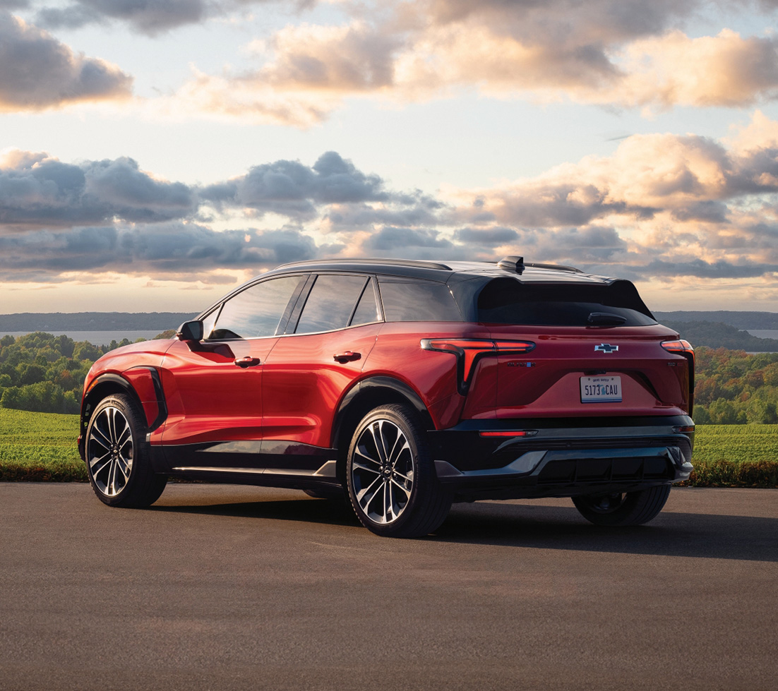 Red Chevrolet Blazer EV overlooking a scenic landscape