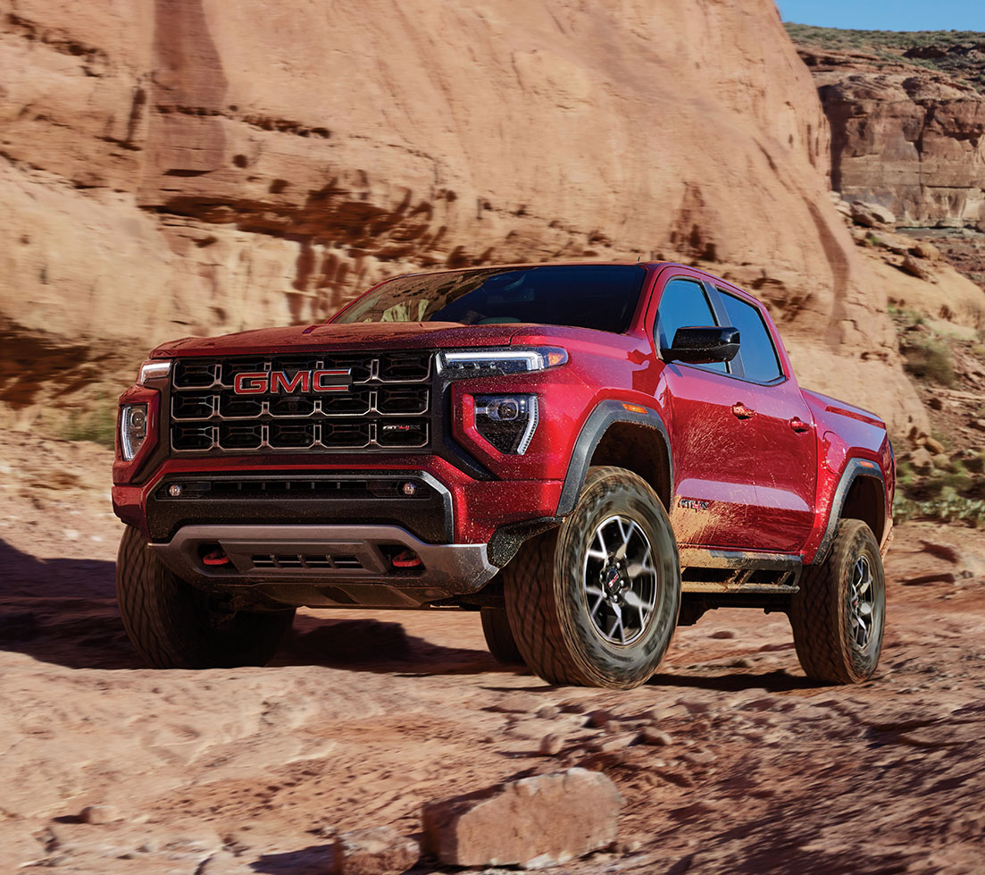 Rugged red GMC Canyon on a rocky desert trail